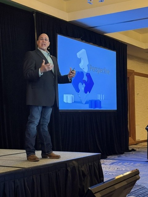 Dr. Chris Young presenting on stage